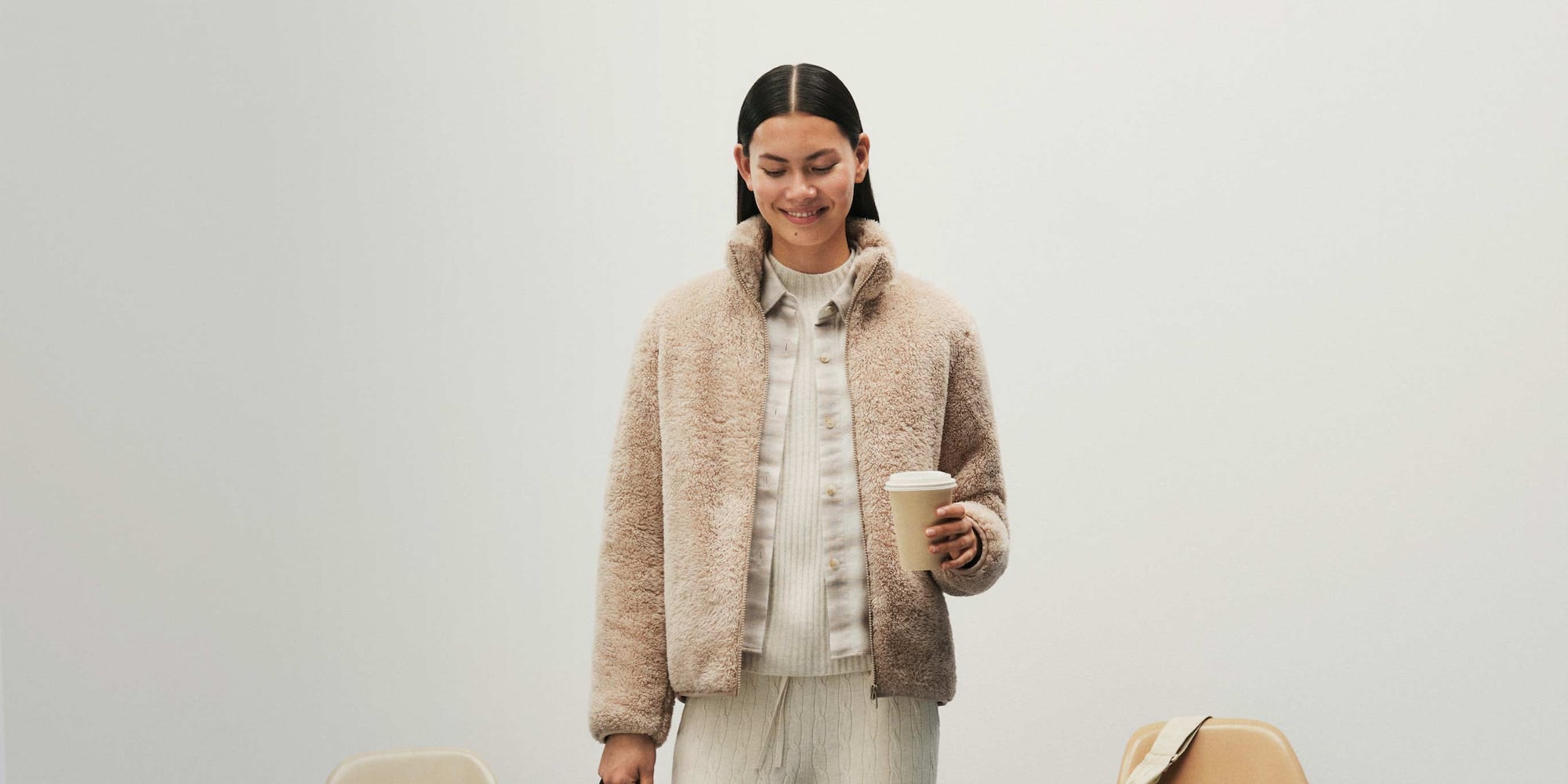 model wearing Fluffy Fleece Jacket in beige with a light beige shirt, cream jumper and cream knit trousers