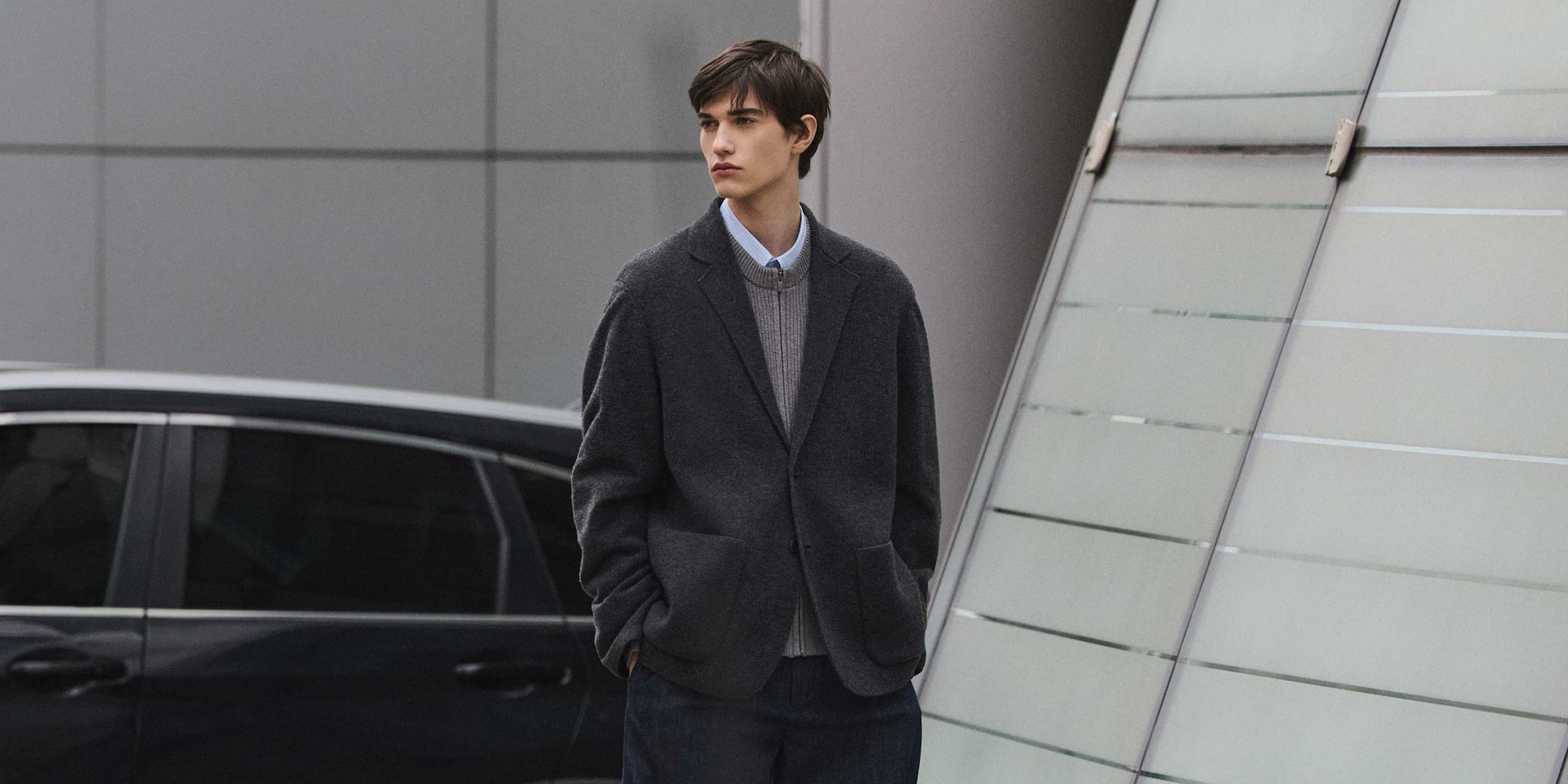 model wearing Knit Jacket in dark grey over a grey knit