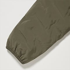 袖口と裾の脇から後ろにかけてはストレッチテープを伸ばし付けし、ギャザーを寄せて冷気の侵入を軽減。