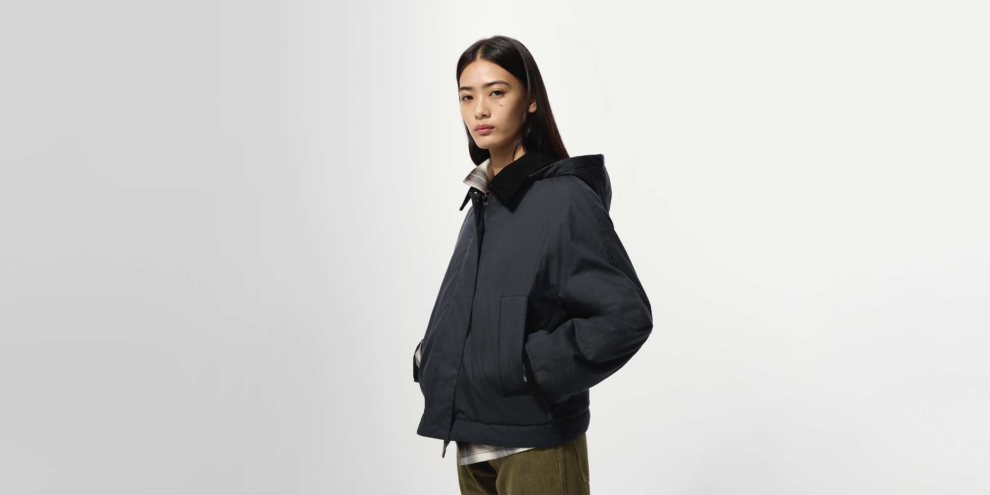 model wearing PUFFERTECH Short Jacket in navy with a checked shirt and khaki trousers