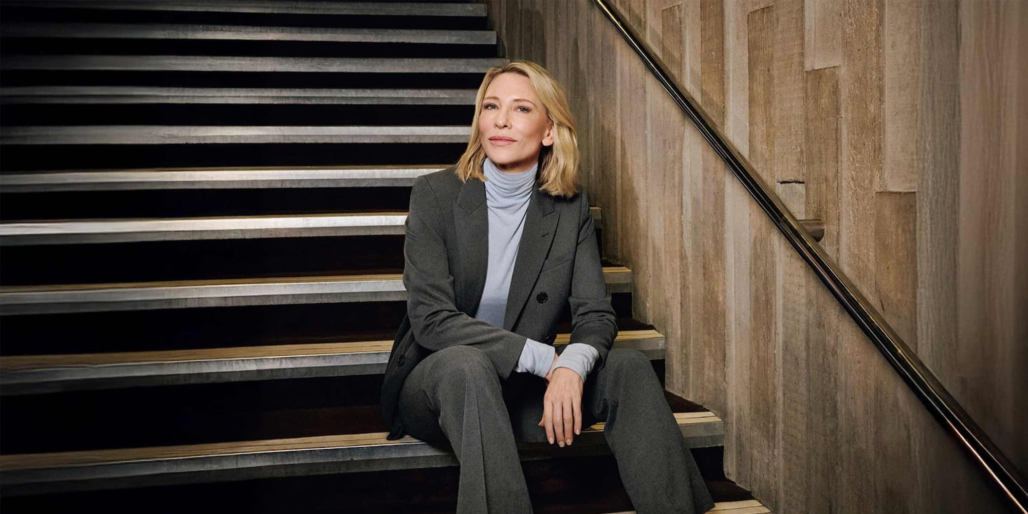 model wearing AIRism Soft Cropped T-Shirt in navy with grey joggers and a white parka tied at the waist