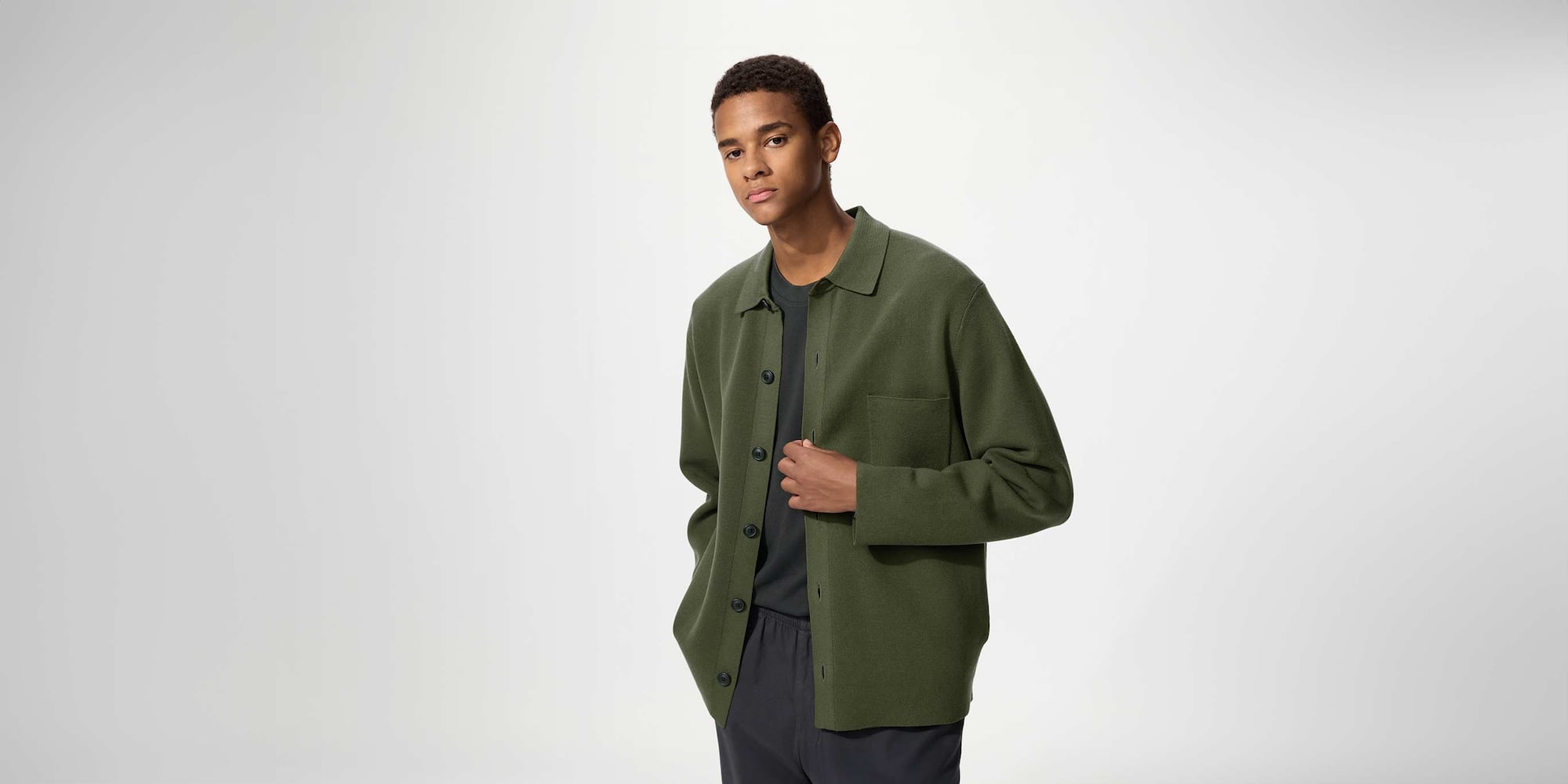 model wearing Milano Ribbed Shirt Collar Cardigan in green over a dark grey T-shirt and trousers