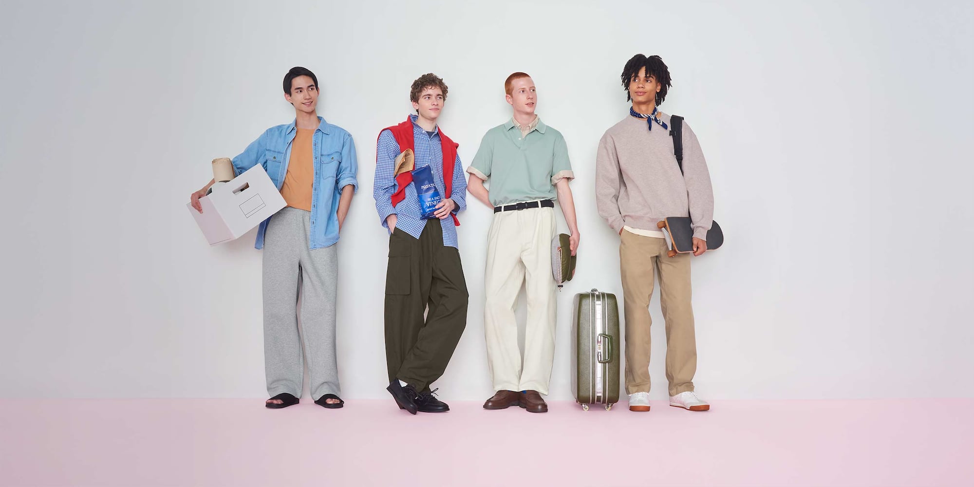 model wearing Barrel Leg Trousers in off white with a blue jumper over a white shirt