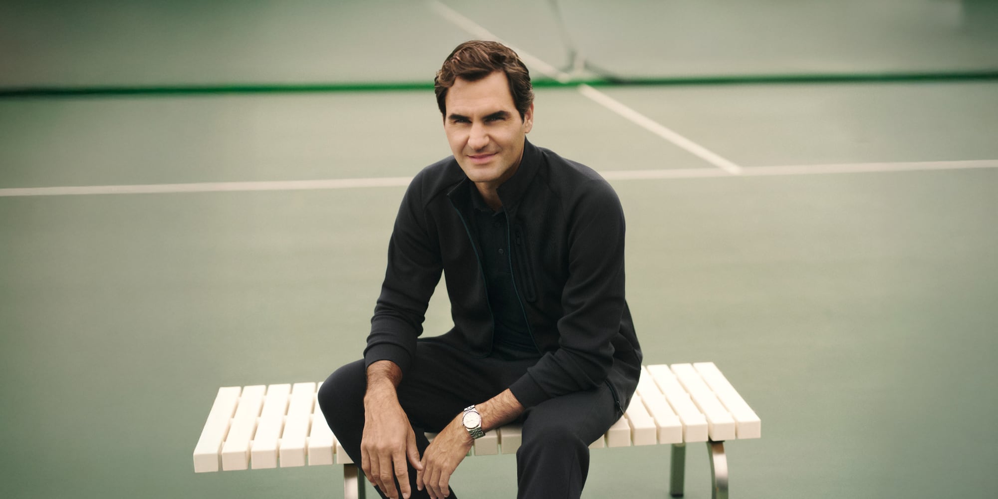 Global Brand Ambassador Roger Federer wearing a black jacket, polo shirt and trousers