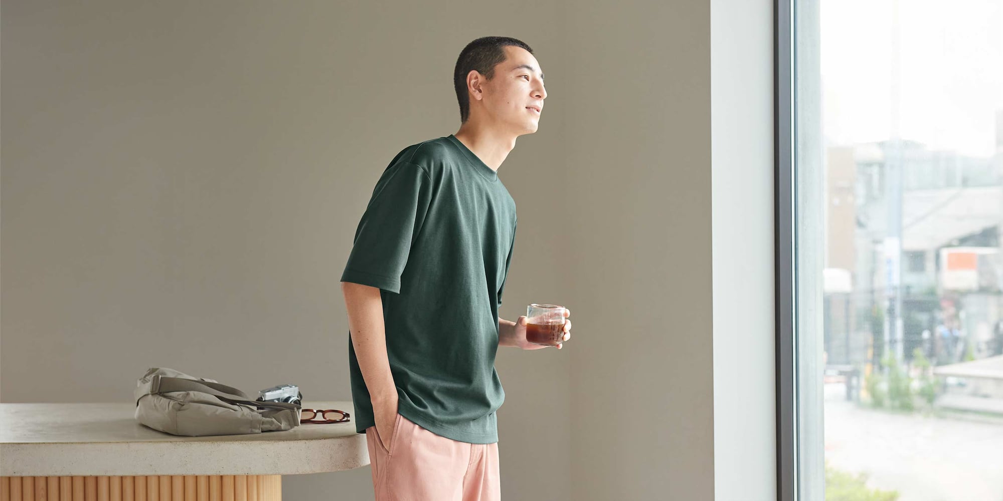 model wearing AIRism Cotton Oversized Crew Neck T-Shirt in dark green