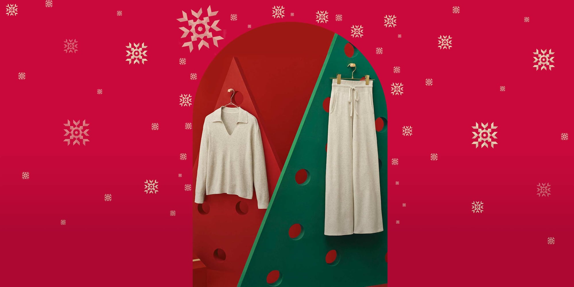 Washable Knit Ribbed Trousers in natural with a coordinating polo jumper hanging against red and green background on gold hangers