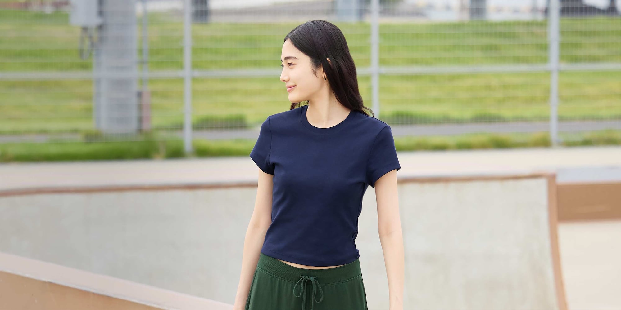 model wearing Mini T-Shirt in navy with green joggers