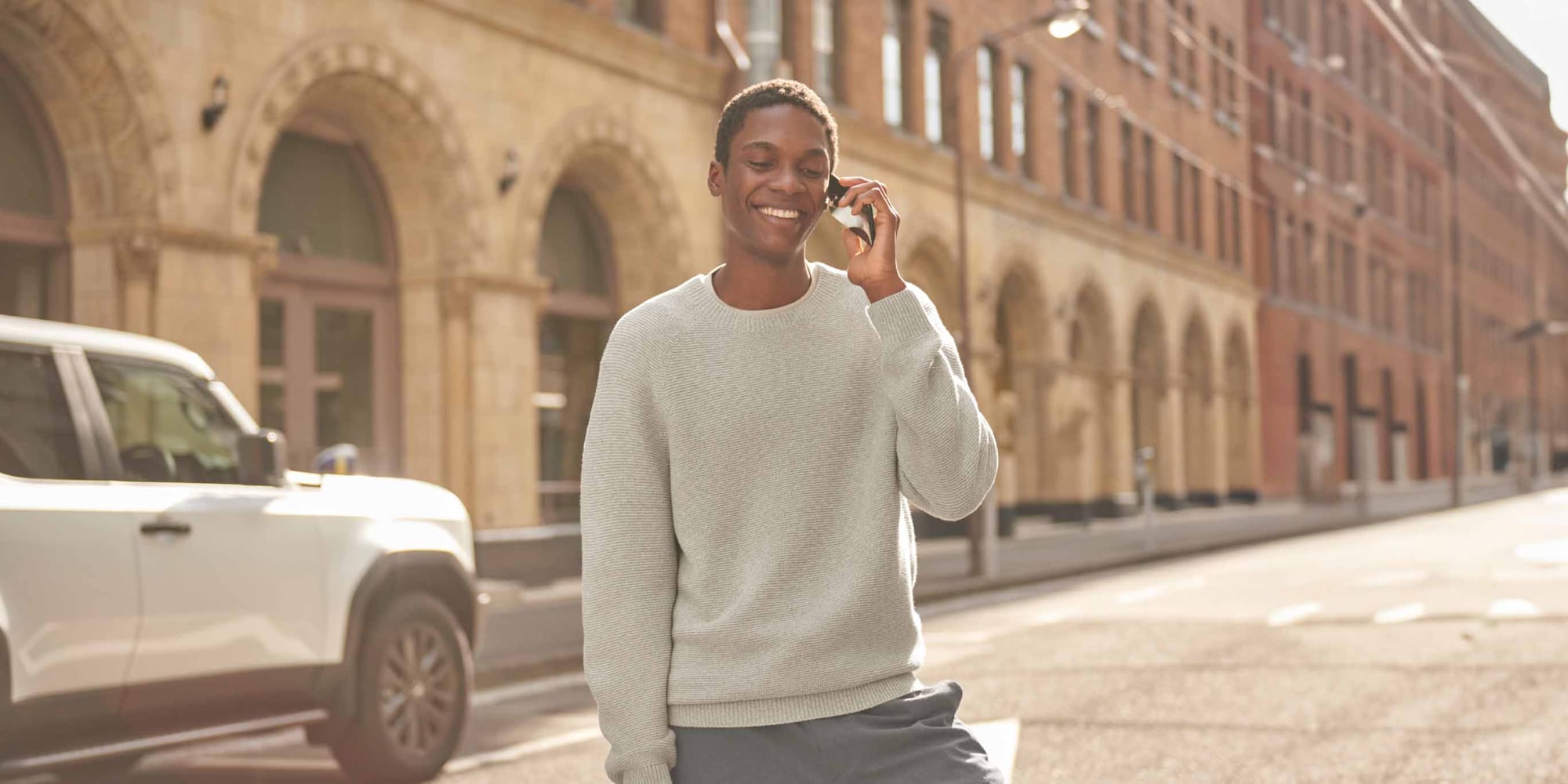 models talking on the phone while wearing Uniqlo Washable 3D Knit Seamless Crew Neck Jumper in light grey