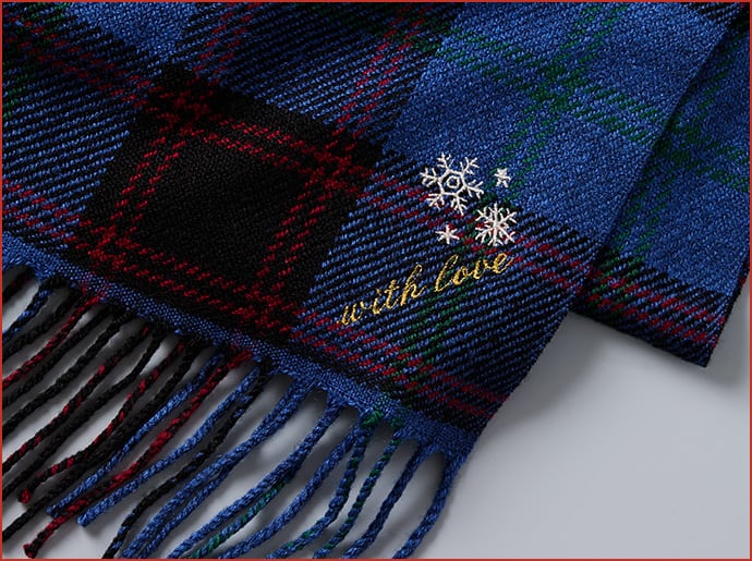 blue checked scarf embroidered with snow flakes and the words 'with love'