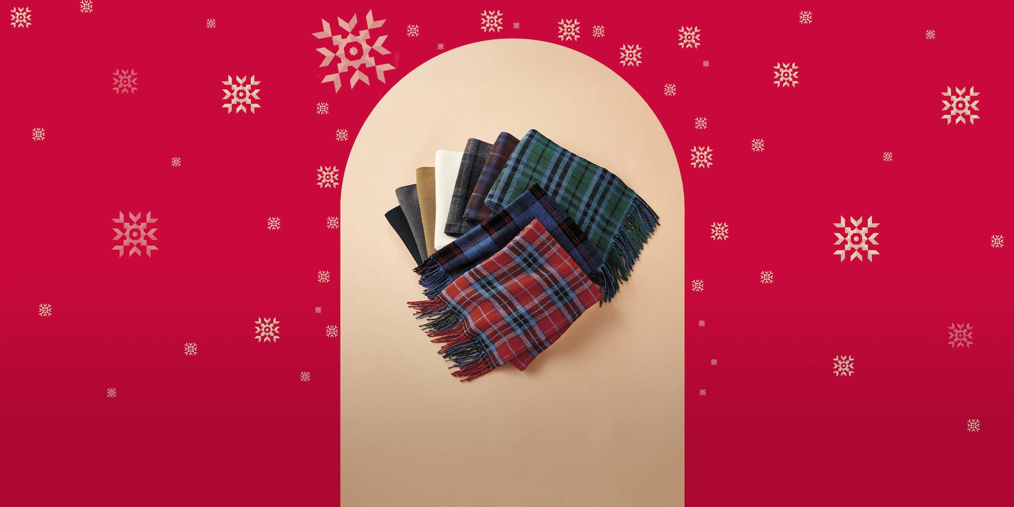 pile of folded HEATTECH scarves in plain and checked designs