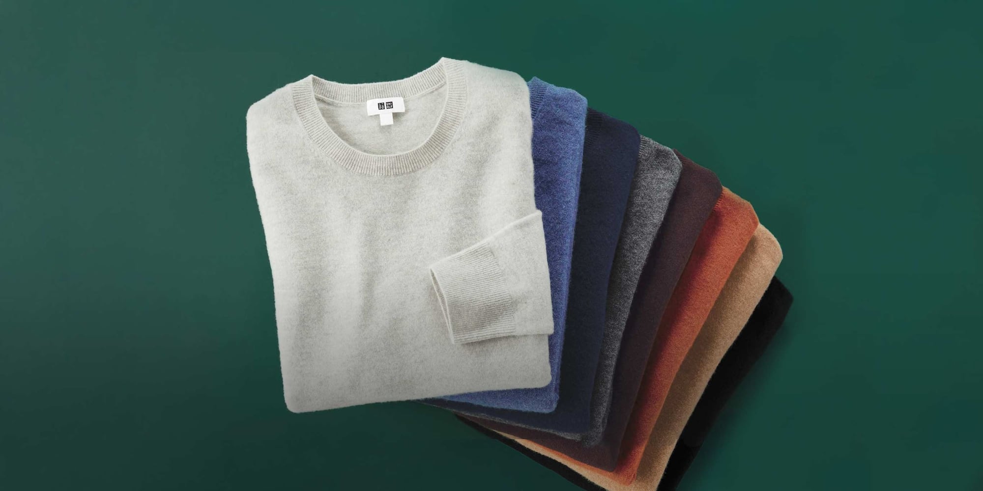 pile of folded 100% Cashmere Crew Neck Jumpers in different colours