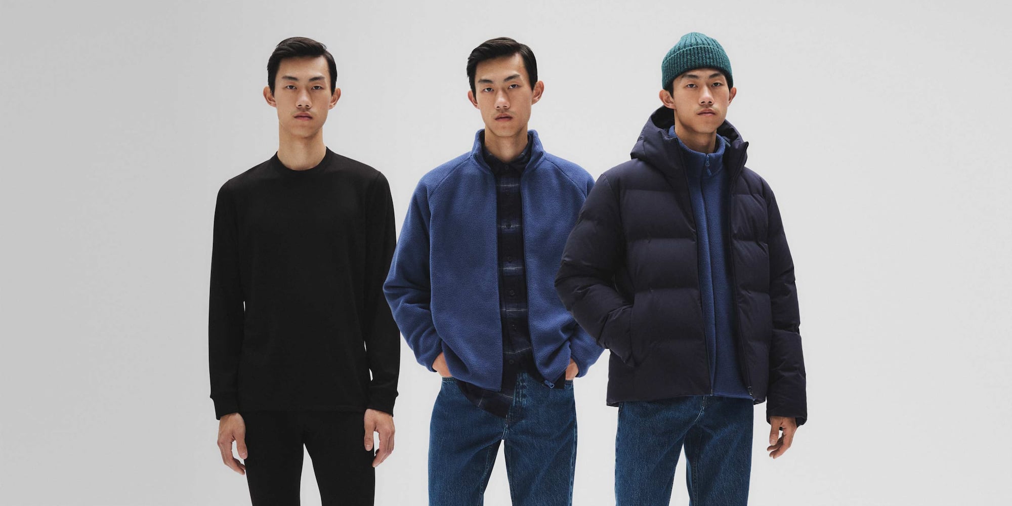 model wearing HEATTECH Ultra Warm Crew Neck T-Shirt in black on its own, then under a shirt and fleece, then under a fleece and down jacket