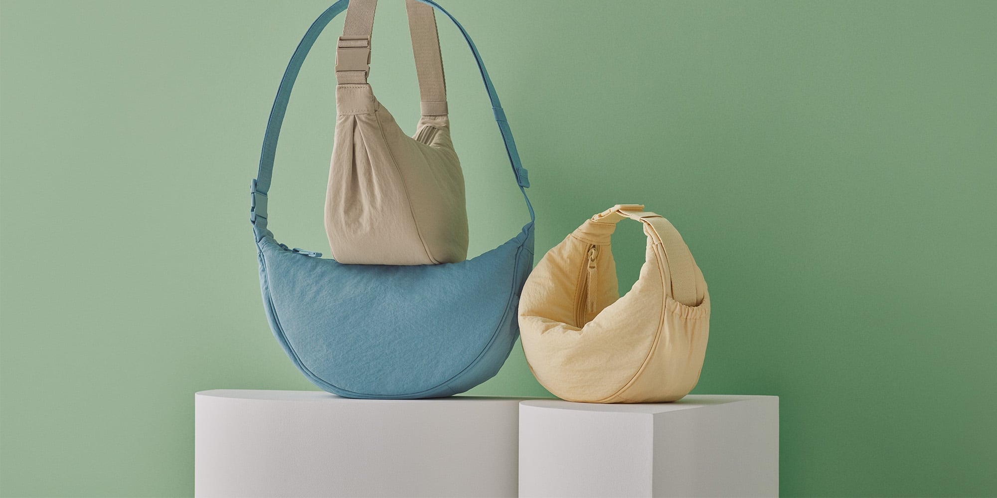 arrangement of three bags against a green background