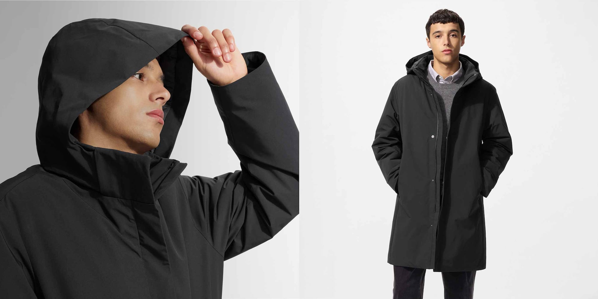 Model trägt schwarzen Daunenmantel, grauen Pullover, weißes Hemd und schwarze Hosen.