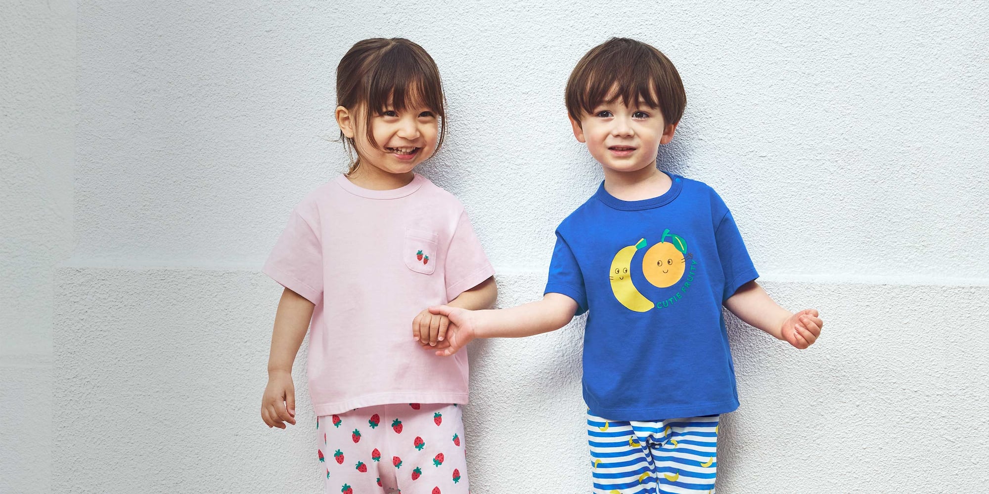 two models wearing uniqlo Short Sleeve T-Shirts while holding hands