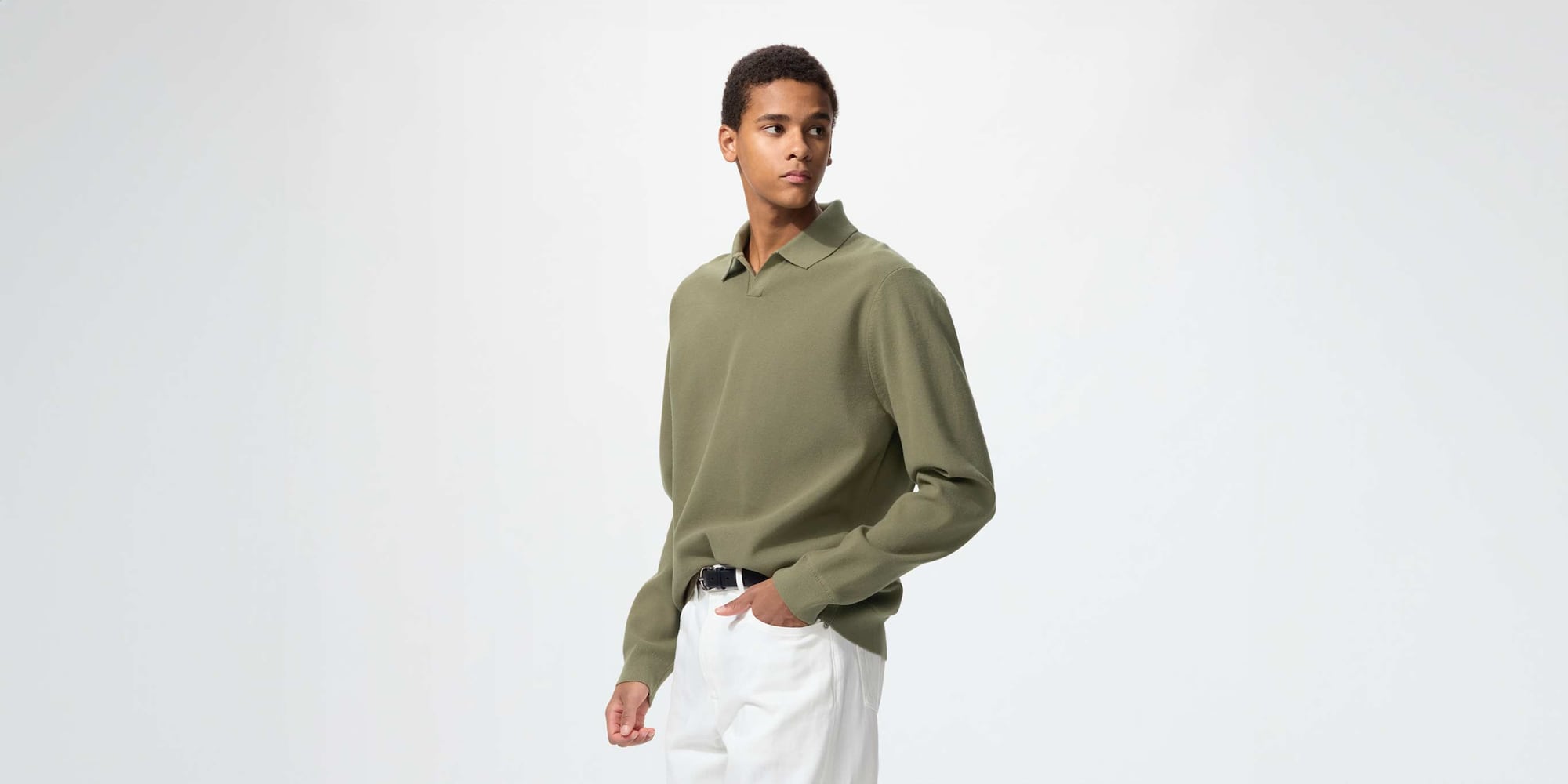 model wearing Washable Milano Ribbed Skipper Polo Jumper in green with white jeans and a black belt