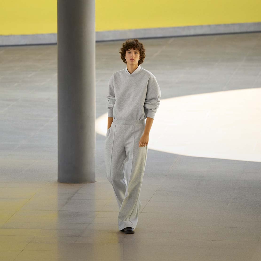 model wearing Sweat Straight Trousers in grey with a matching sweatshirt