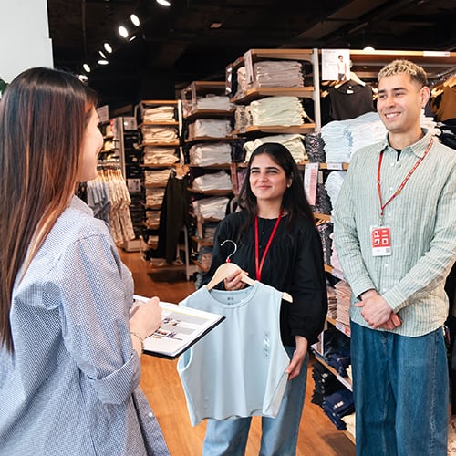 Assistant store manager talking to two team members