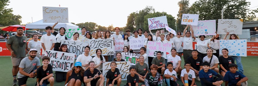 Street Soccer group with positive affirmation signs