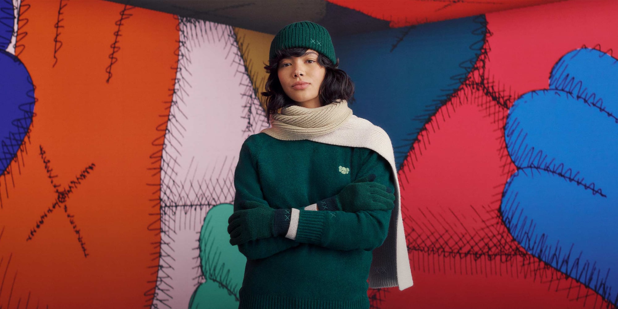 two models wearing KAWS WINTER knitwear from UNIQLO