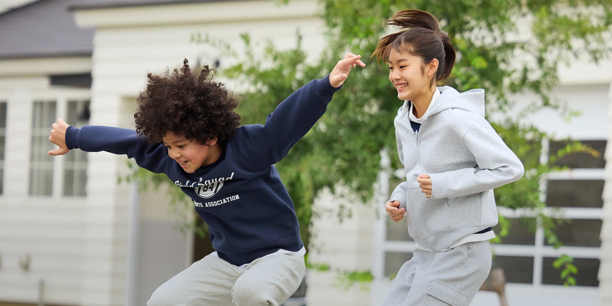 two models running and jumping while wearing UNIQLO sweats