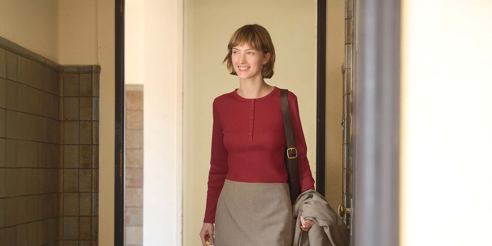 Model wearing Uniqlo Long Sleeve Ribbed Henley Neck T-Shirt in red