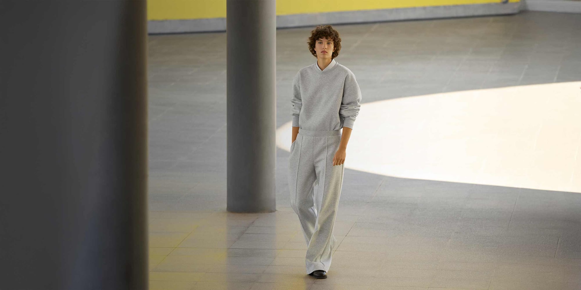 model wearing Sweat Straight Trousers in grey with a matching sweatshirt and black shoes