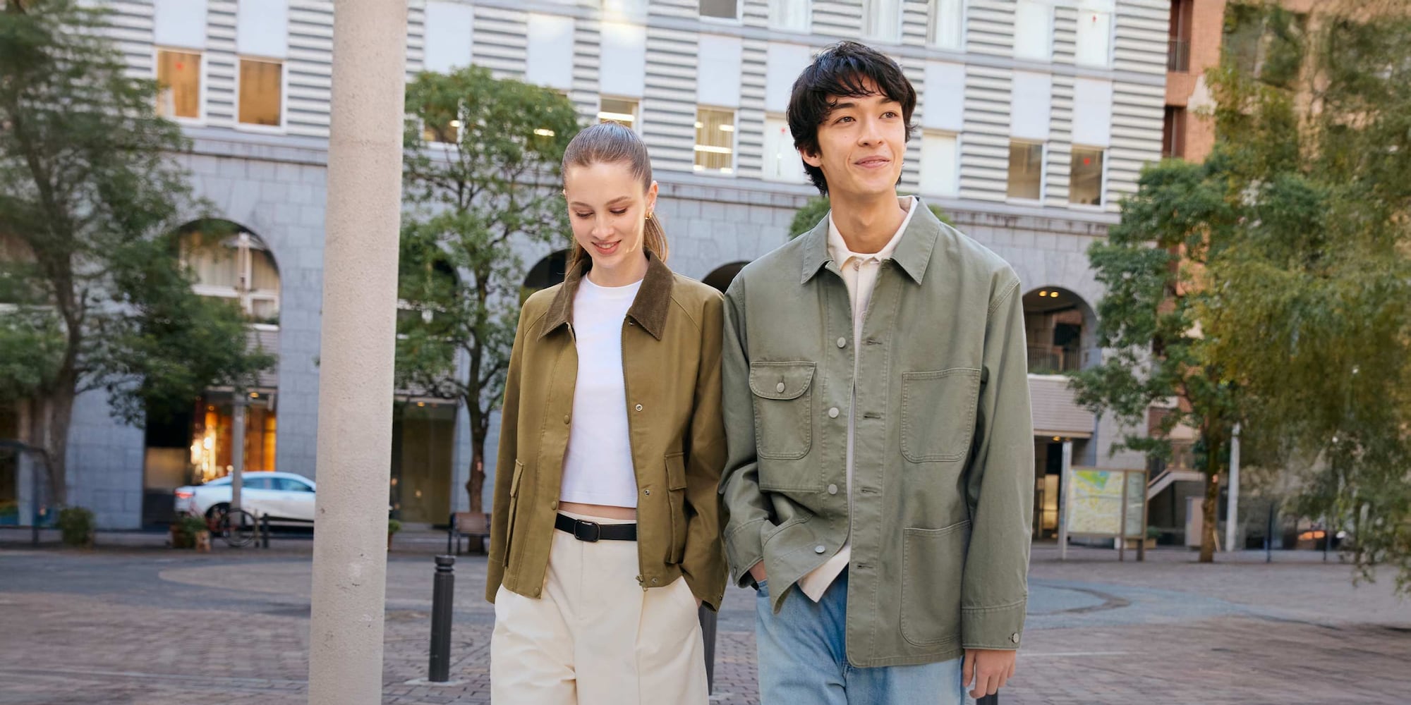 two models walking side by side wearing uniqlo jackets