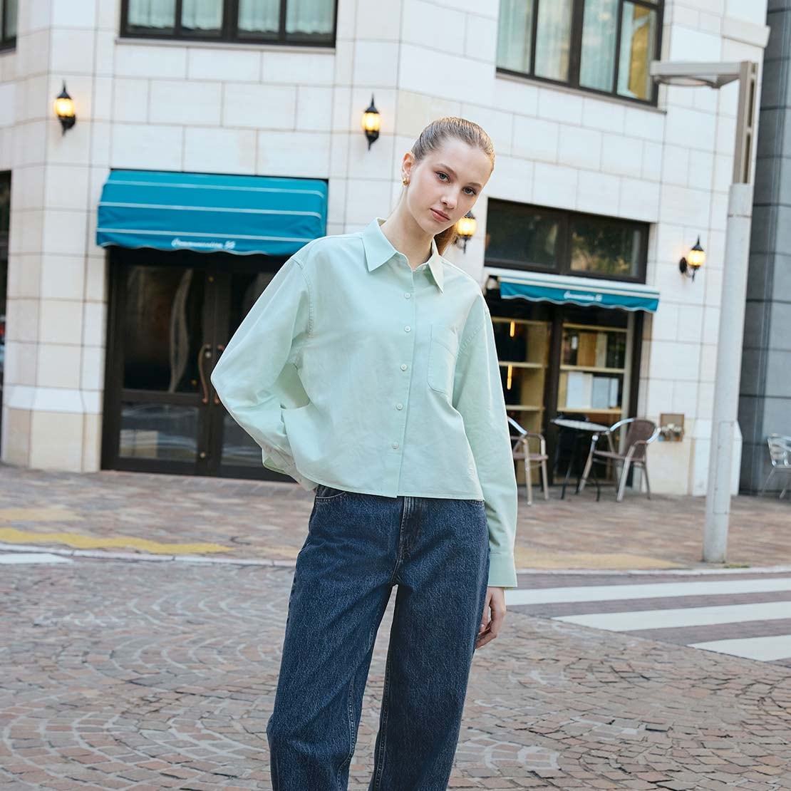 model wearing Oxford Boxy Shirt in light green with blue jeans