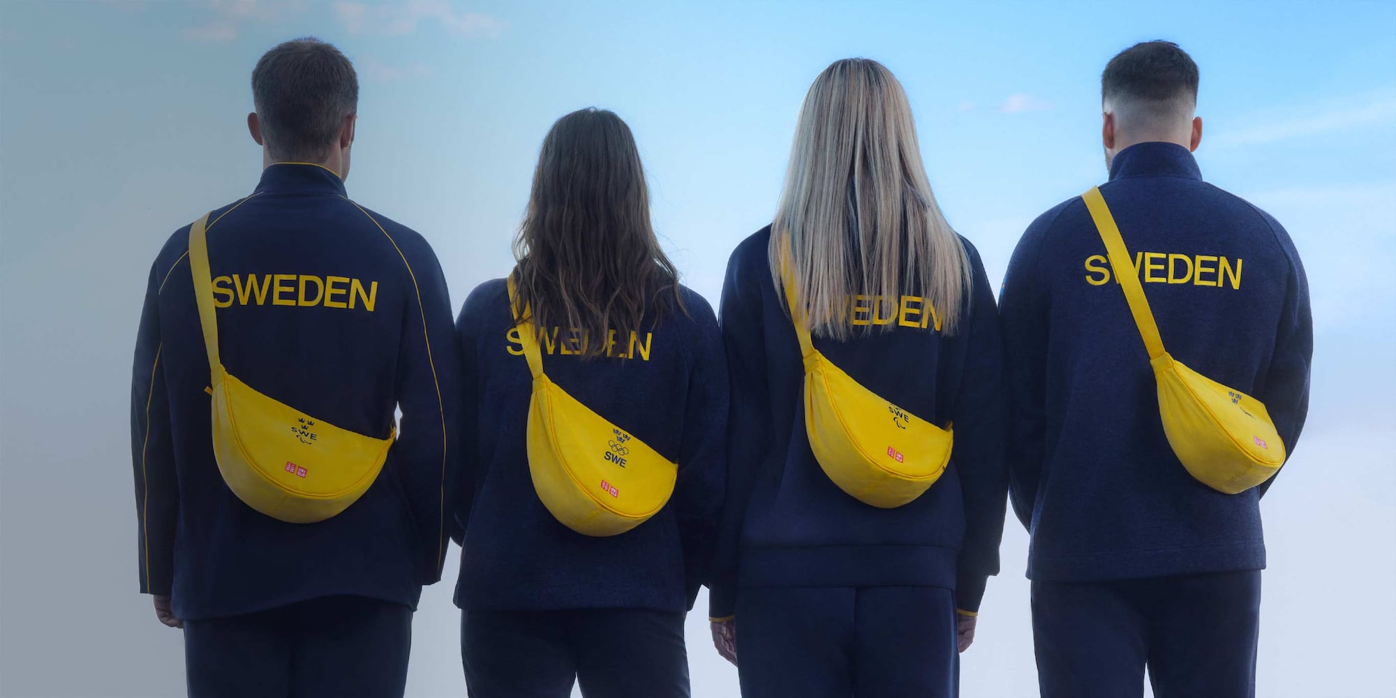 four models wearing blue jackets and yellow cross-body bags with the Sweden Olympic Team logo