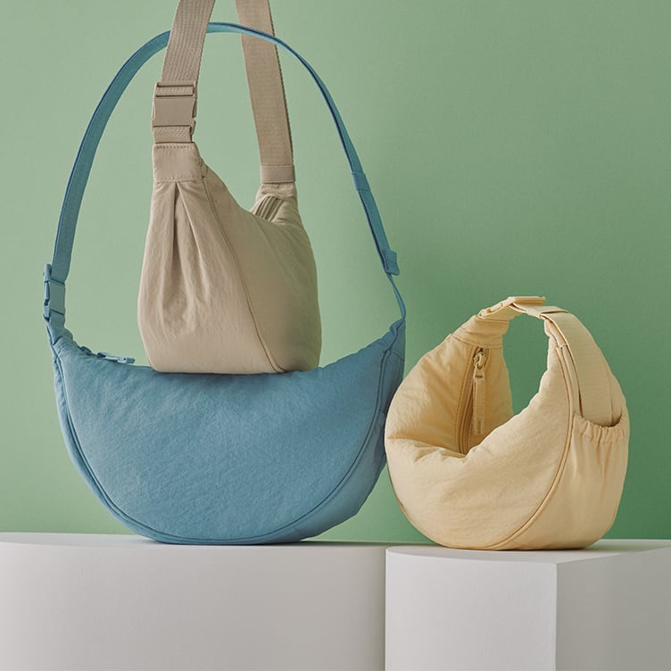 arrangement of three bags against a green background