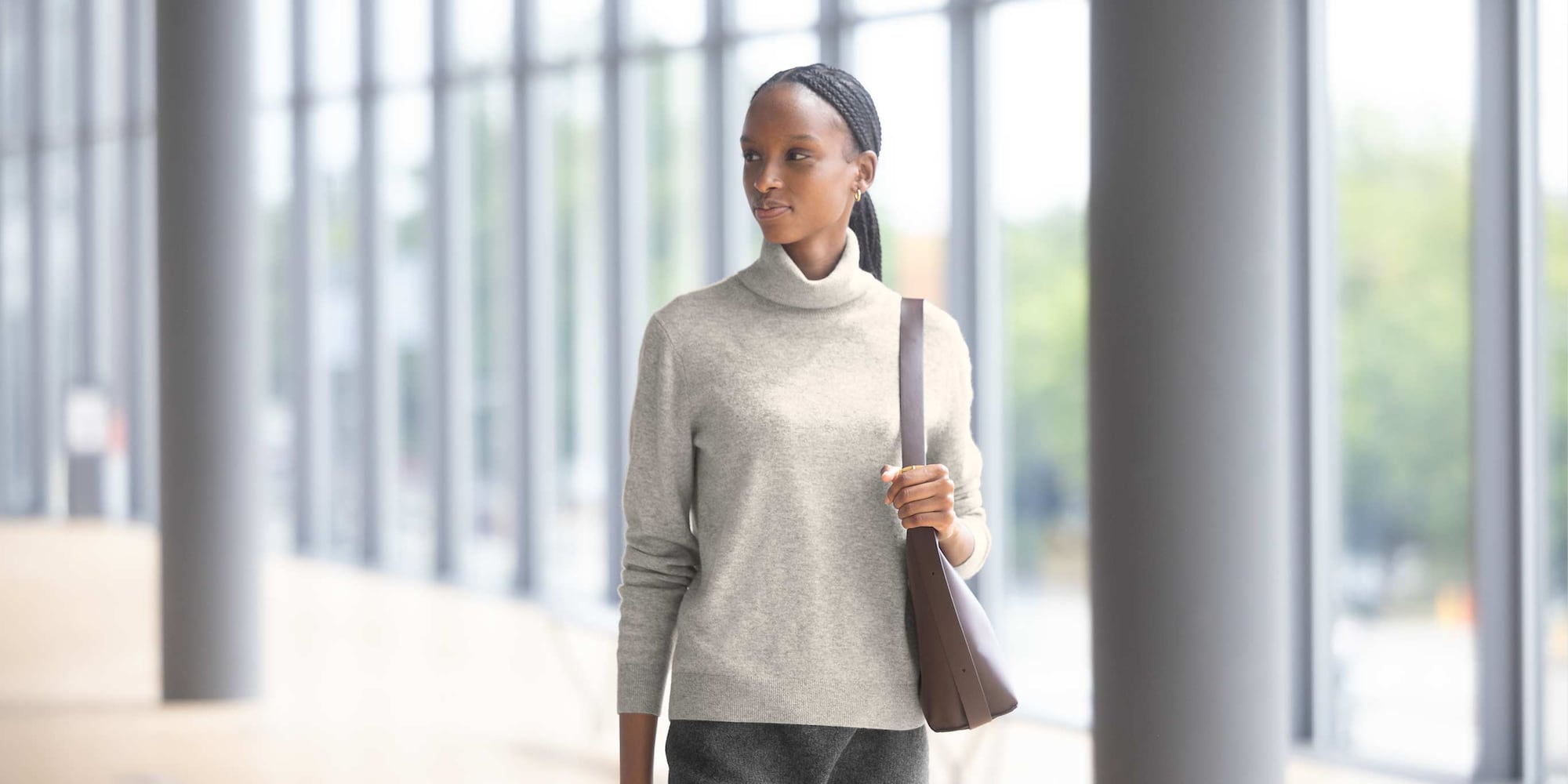 model wearing 100% Cashmere Turtleneck Jumper in grey with a brown shoulder bag