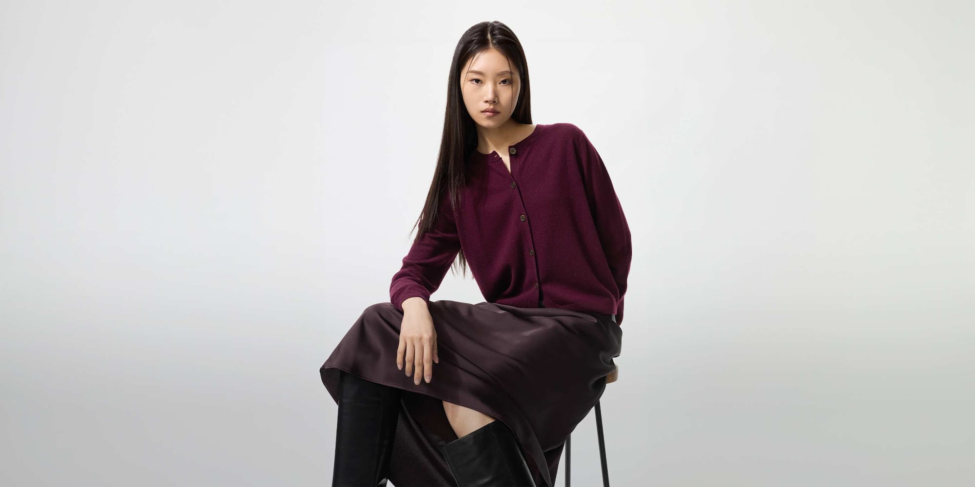 model wearing 100% Cashmere Crew Neck Short Cardigan in red with a satin skirt