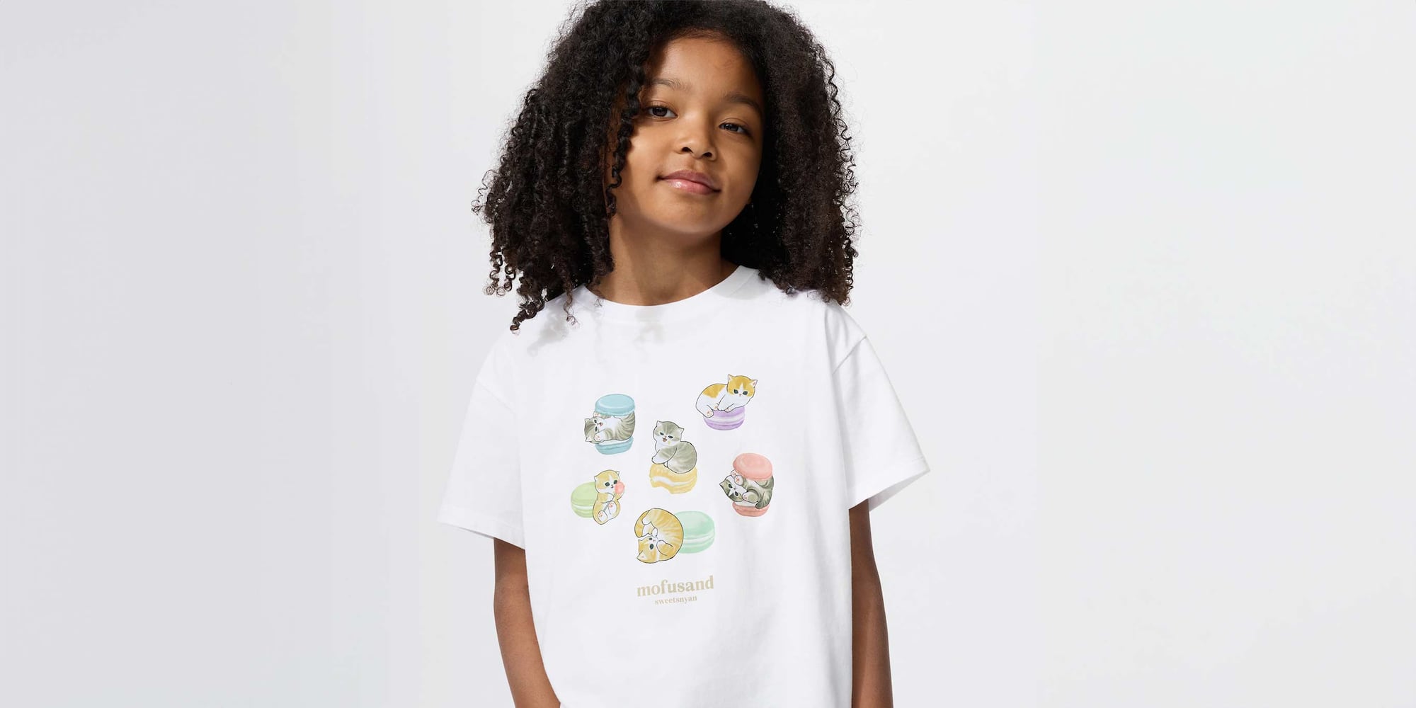 model wearing mofusand UT Graphic T-Shirt in white, featuring mofusand cats in macarons