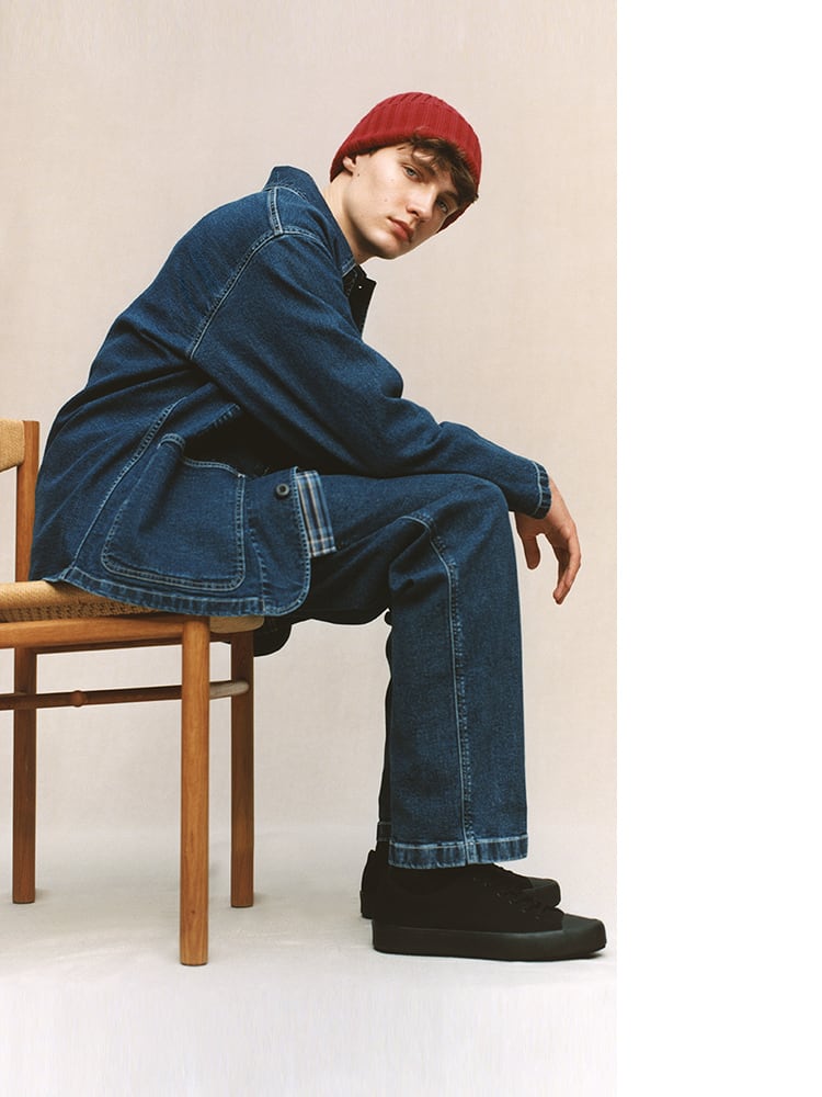 Utility jacket and work pants with attention to detail in stitching and pocket design. Checked shirts and knit hats add a playful touch.