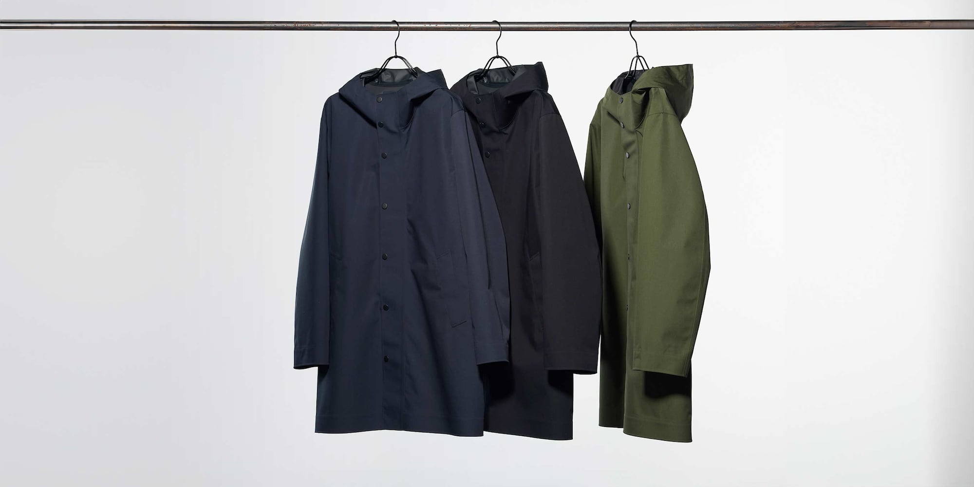 three BLOCKTECH Coats hanging on a rail
