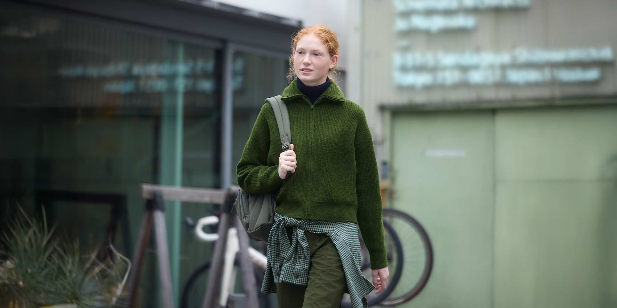 model wearing Soufflé Yarn Full-Zip Cardigan in green with green trousers and a green checked shirt