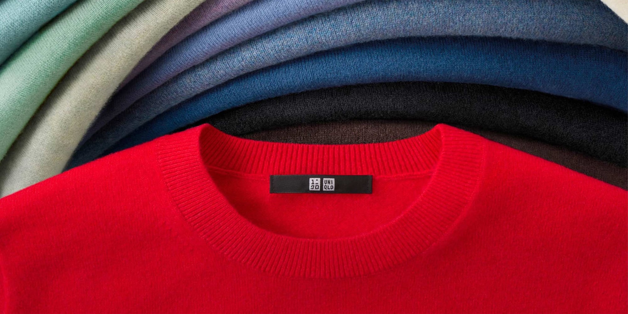 close-up shot of a pile of cashmere crew neck jumpers in multiple colours