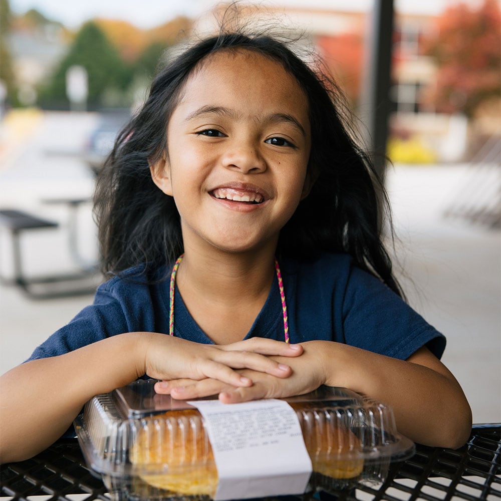 Girl smiling with baked goods