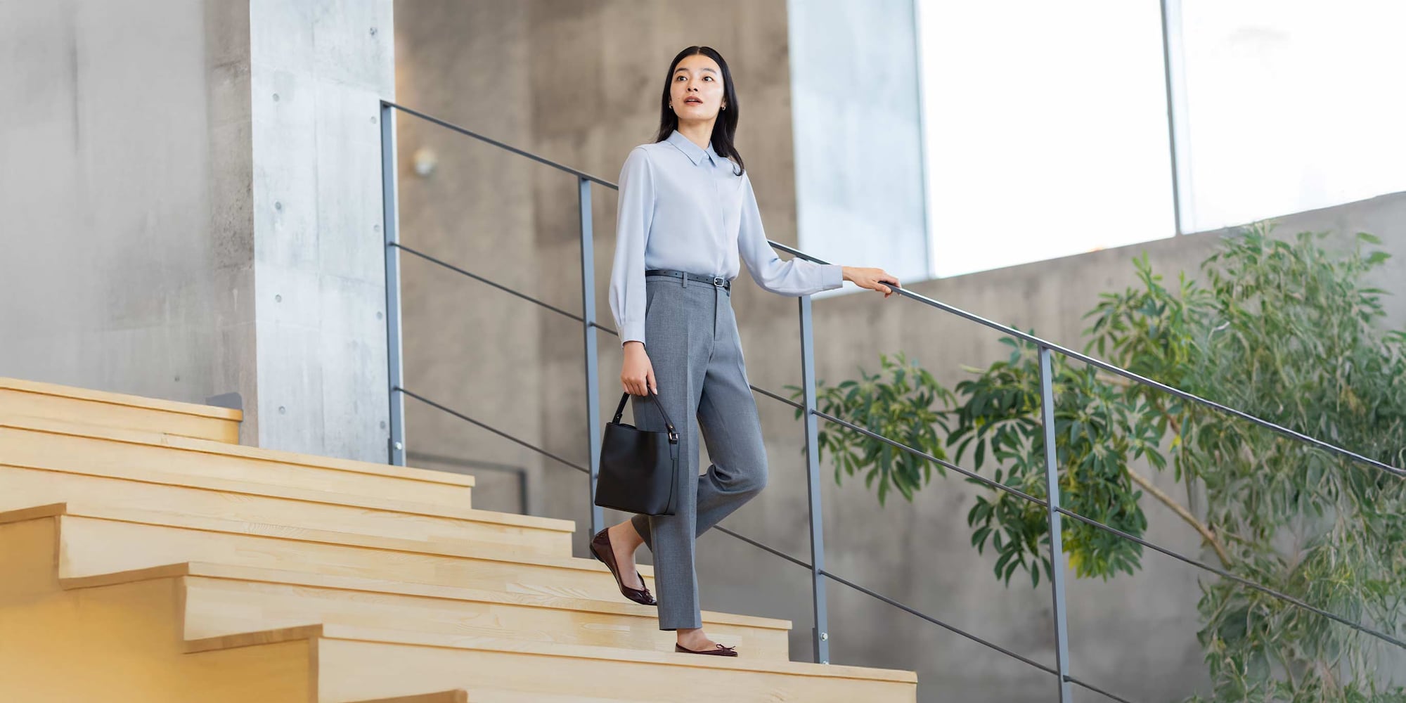 model wearing Smart Ankle Trousers in brown with matching jacket and an off white knitted polo