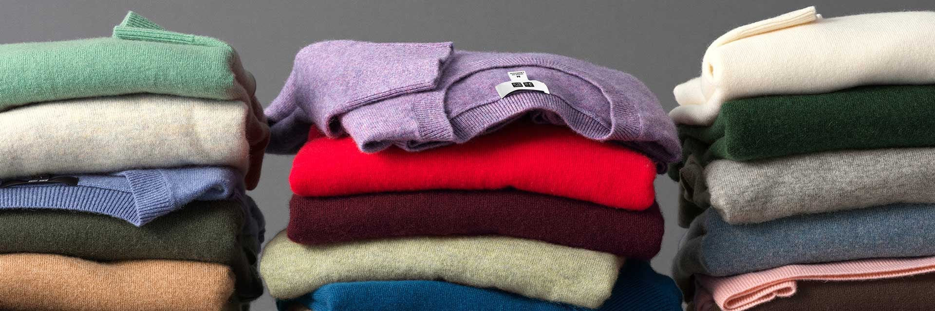 Cashmere sweaters in multiple colors like purple, red, brown, blue, green, gray, and white.