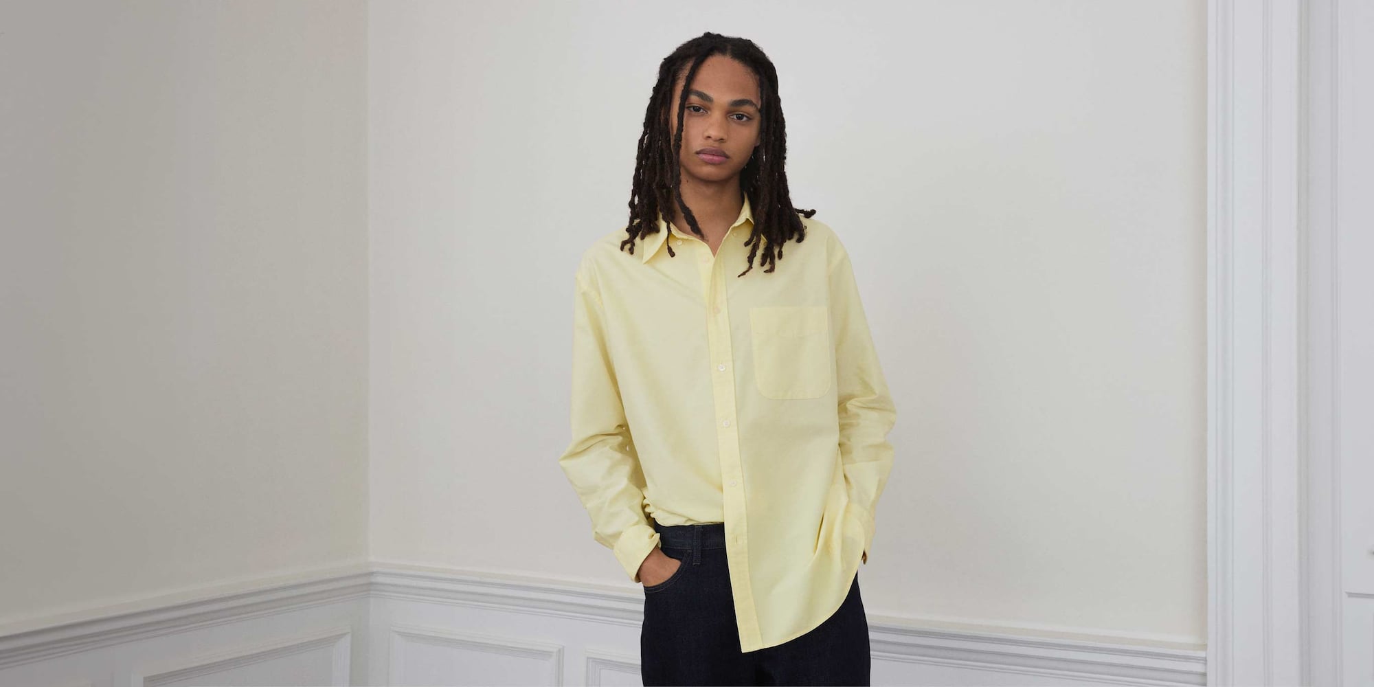 model wearing Oxford Oversized Shirt in yellow with dark wash jeans