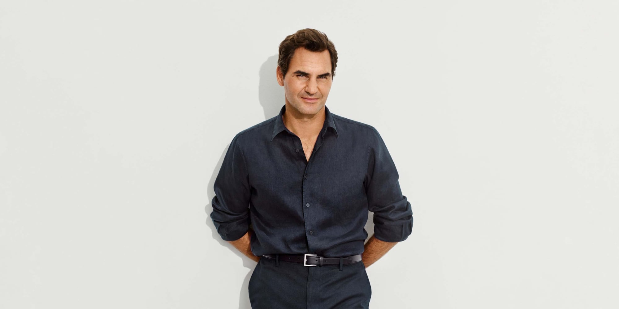 Roger Federer wearing 100% Premium Linen Shirt in navy with navy trousers and a black belt