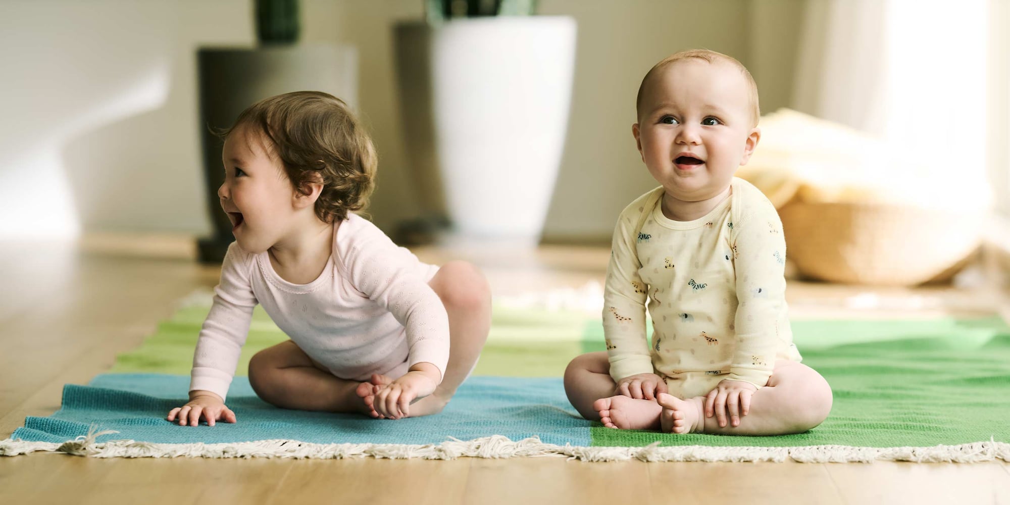 two models wearing bodysuits in pink pointelle and yellow animal print designs