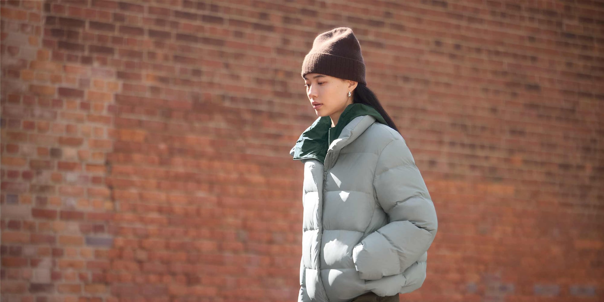 model wearing Powder Soft Down Jacket in blue with a brown hat