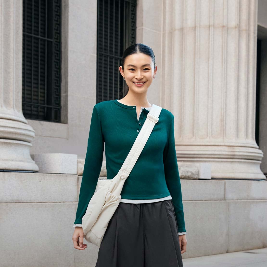 model wearing Ribbed Henley Neck T-Shirt in dark green layered over another Ribbed Henley Neck T-Shirt with dark grey culottes