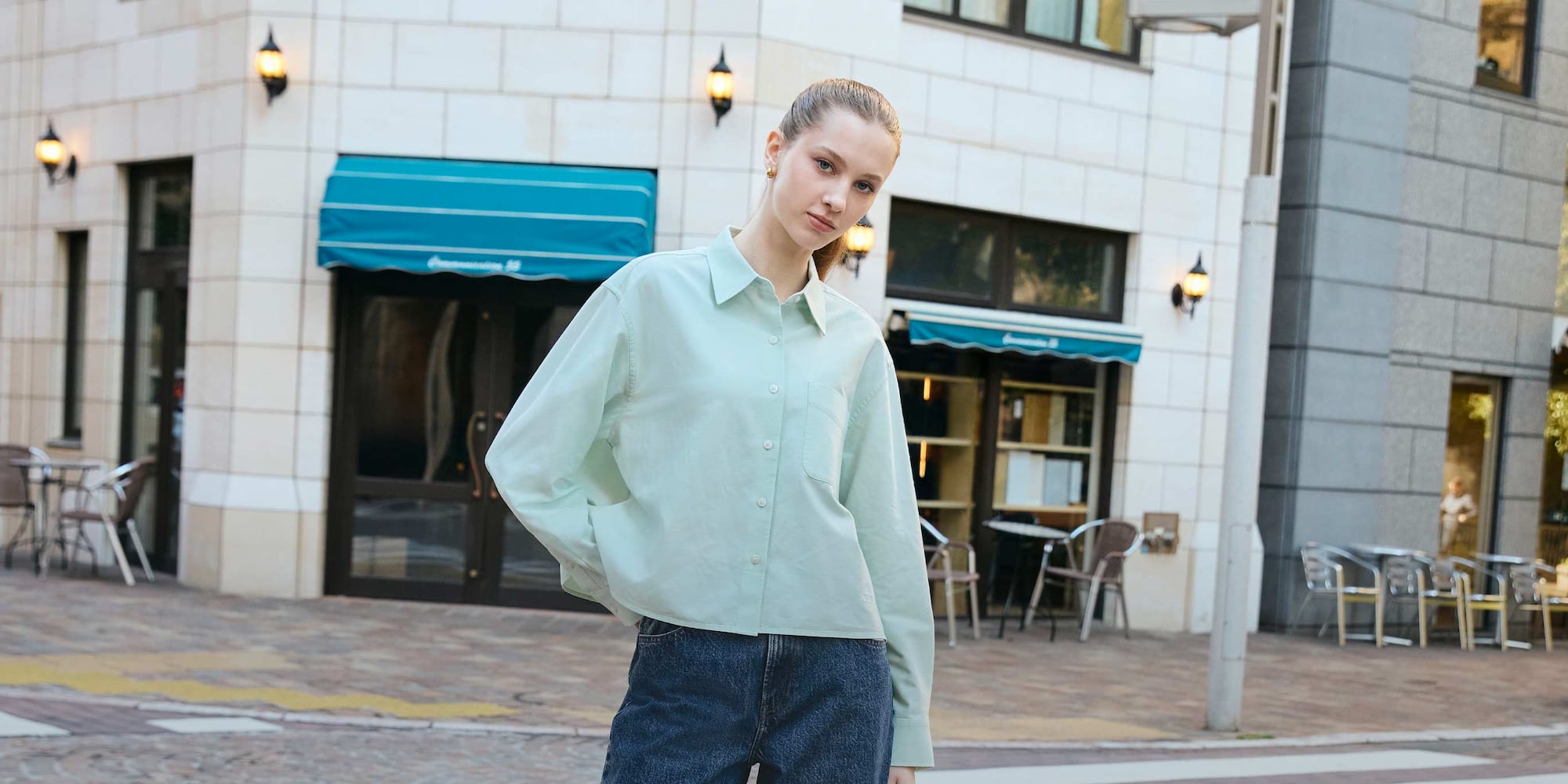 model wearing Oxford Boxy Shirt in light green with blue jeans