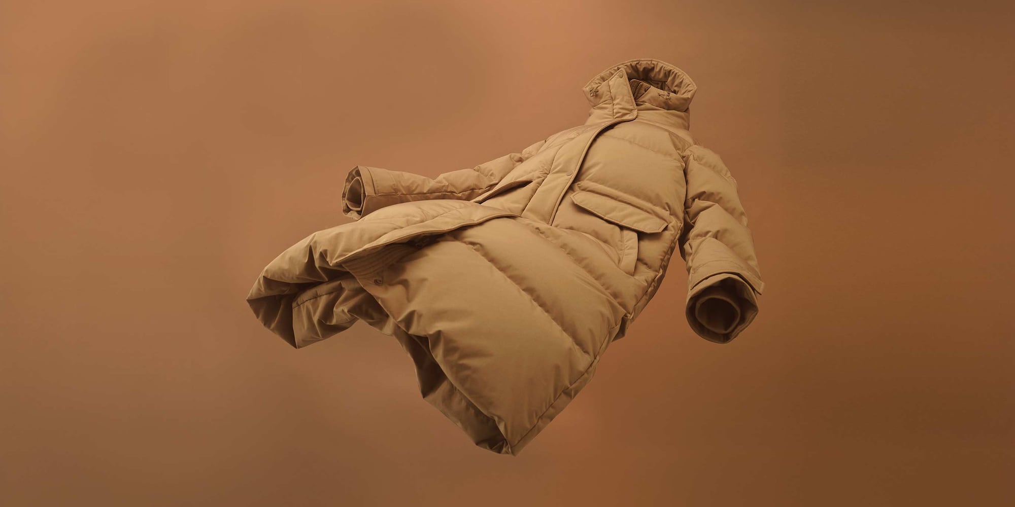 Ultra Warm Down Long Coat in beige floating in the air