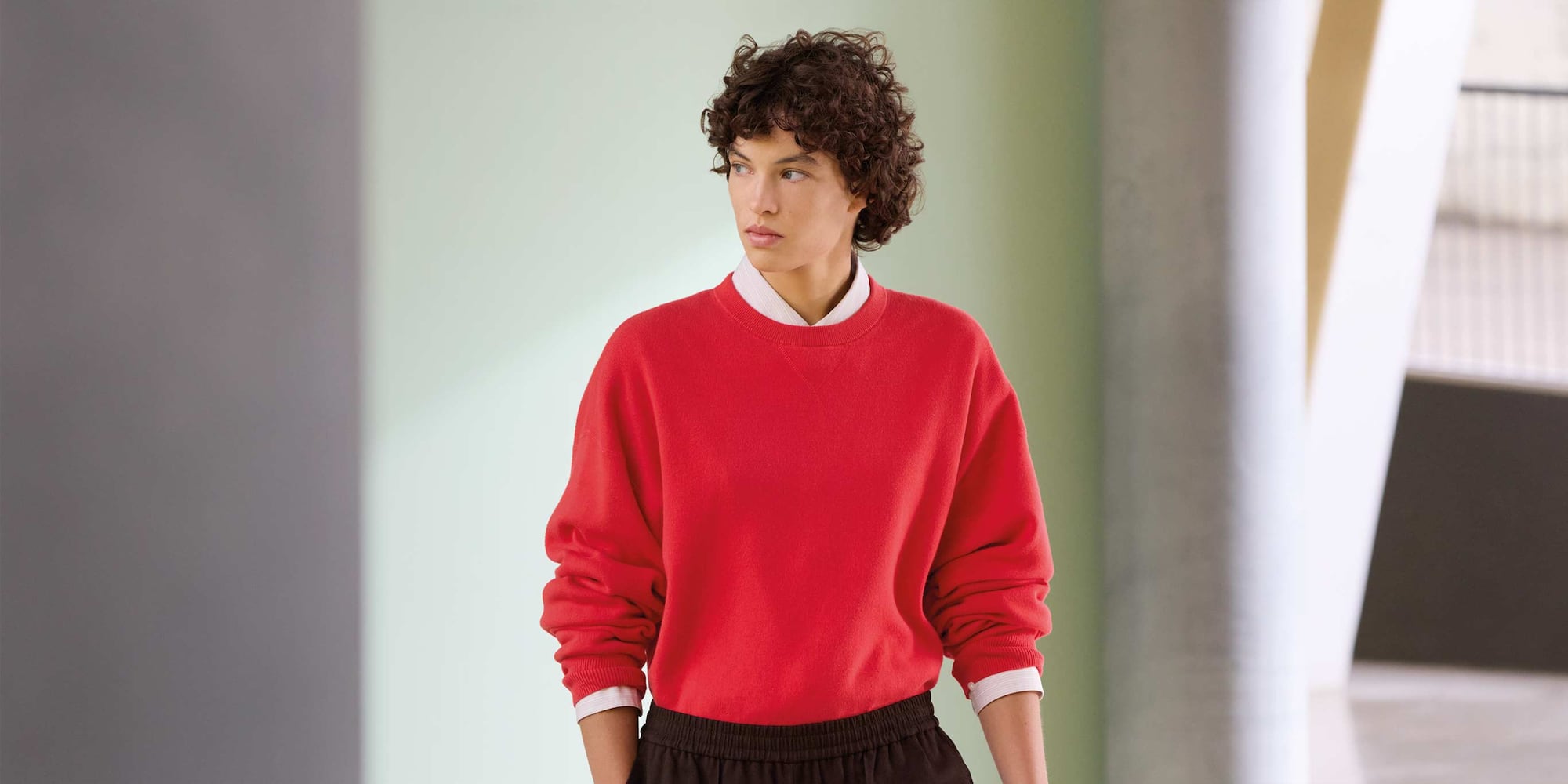 model wearing Smooth Cotton Crew Neck Jumper in red over a shirt and trousers