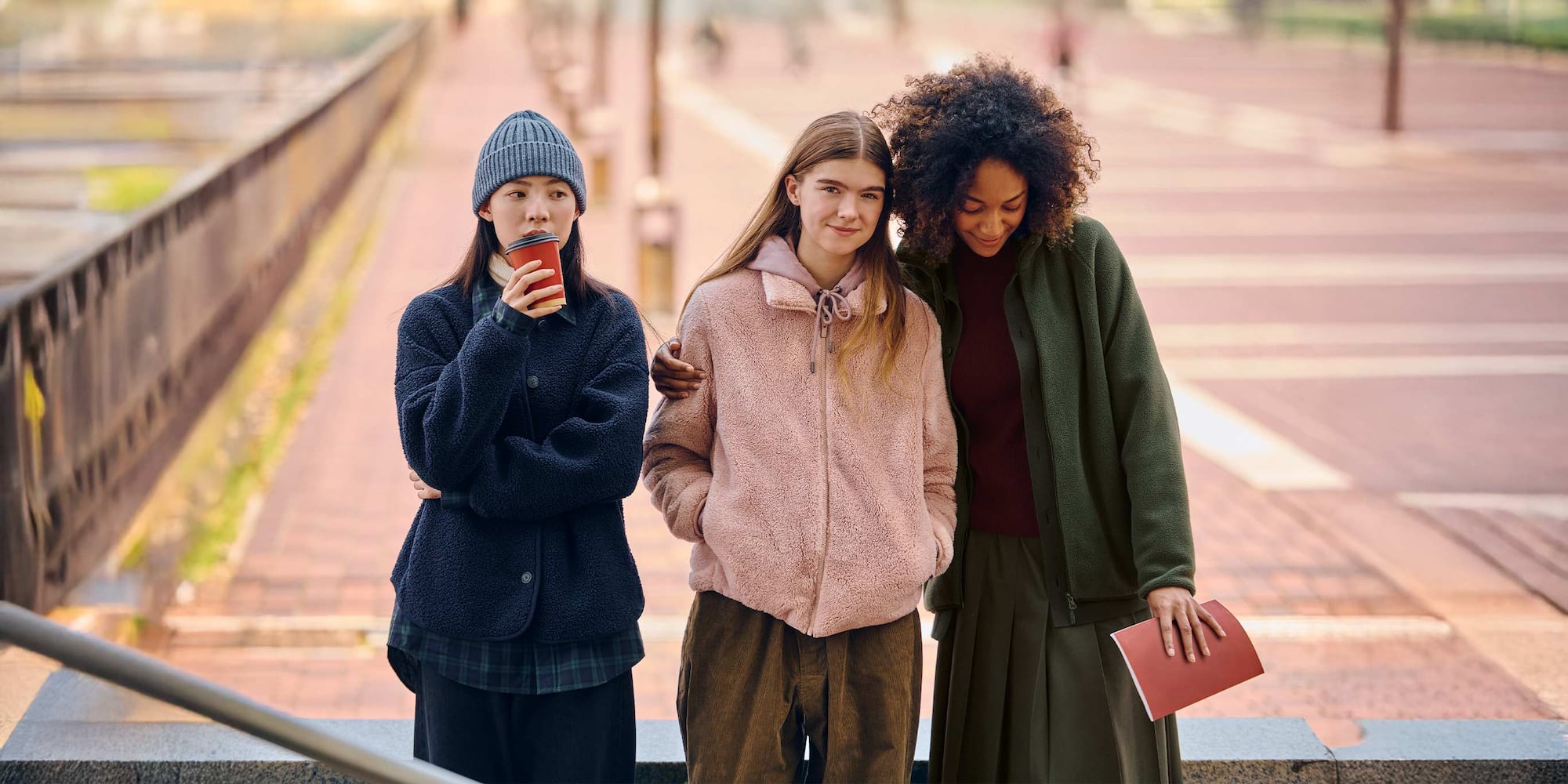 three models wearing UNIQLO fleece jackets in different styles and colours
